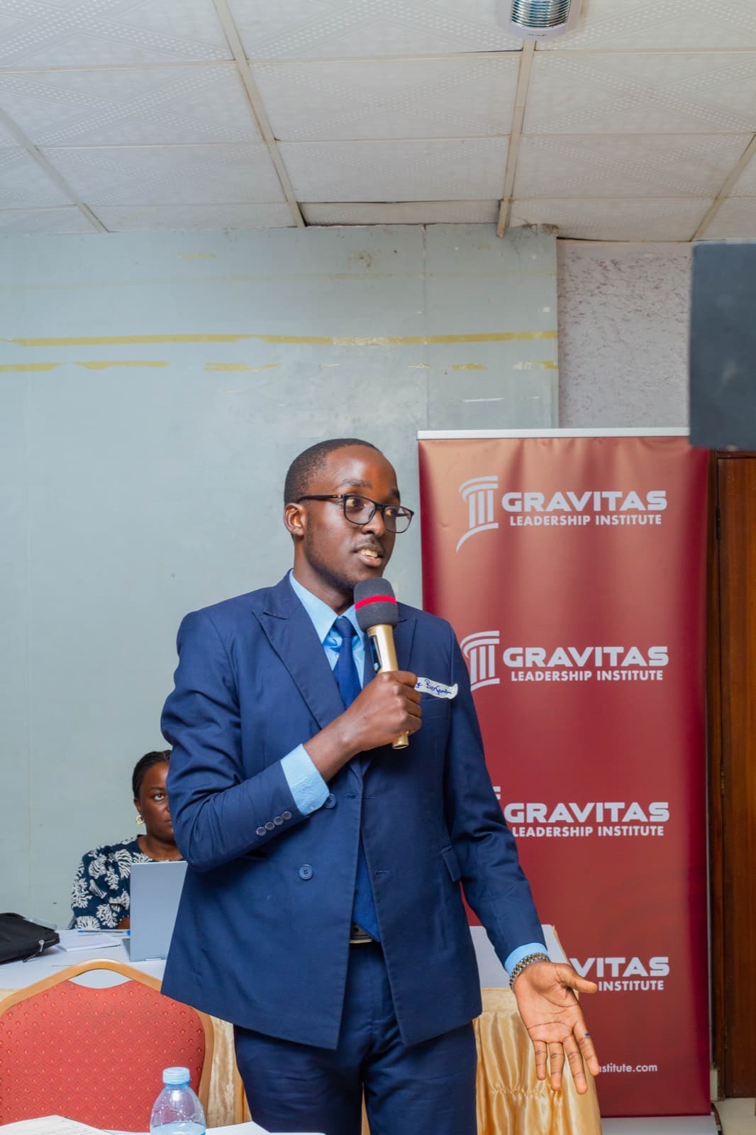 A participant speaking beside the Gravitas banner